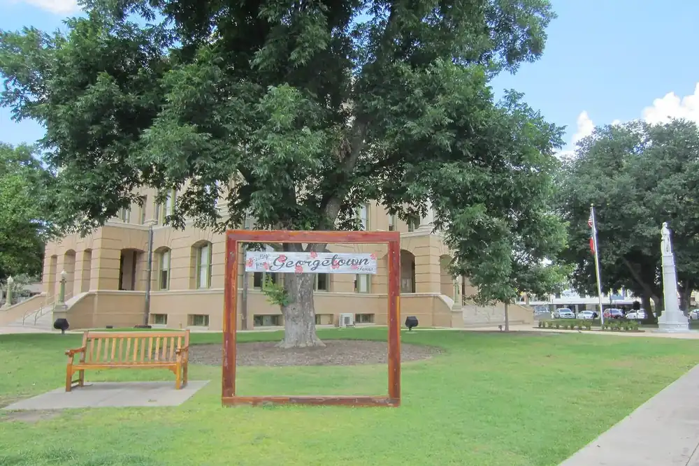 Williamson County Courthouse lawn with a bench and a Georgetown photo frame in Georgetown, Texas
